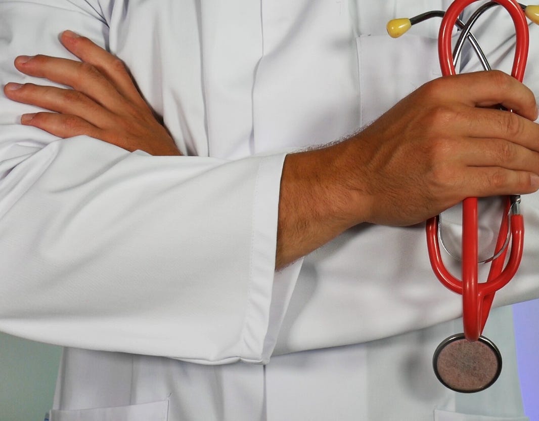 Men in White Coat Standing Beside Woman in White Coat